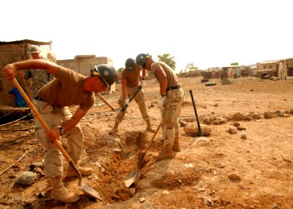 US Navy 080923-N-3560G-004 Seabees assigned to Naval Mobile Construction Battalion (NMCB) 4 dig the foundation for a concrete form during the construction of a new water distribution system photo