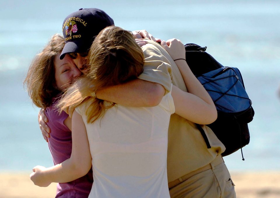 US Navy 080927-N-5758H-064 Lt. Cmdr. Johnny Rogers, assigned to Fleet Surgical Team (FST) 2, greets his wife and daughter upon his return from a week of supporting local, state and federal authorities in Galveston, Texas