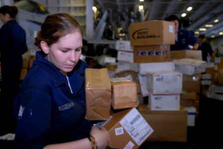 US Navy 080926-N-3610L-161 Machinist's Mate Fireman Ashley Bozeman gathers a stack of packages