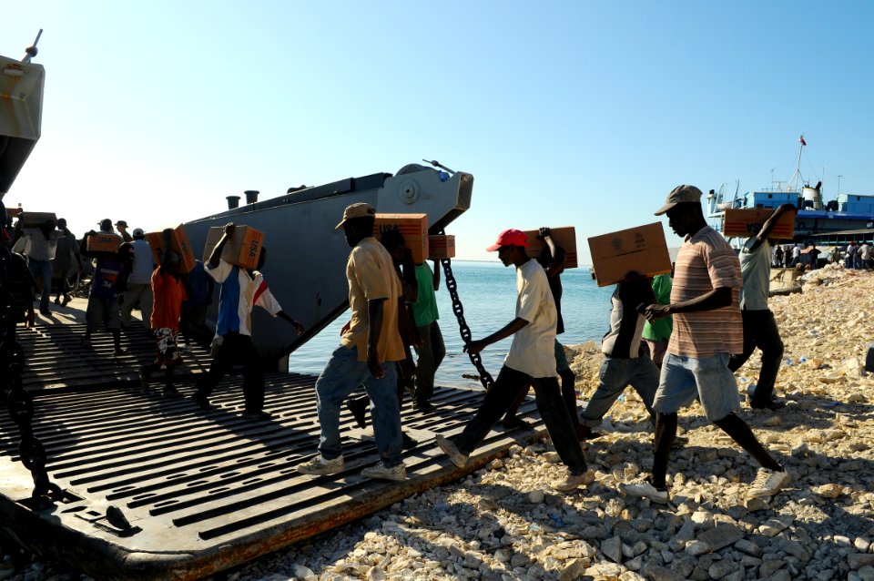 US Navy 080926-N-4515N-047 Haitian civilians unload relief supplies from a landing craft utility