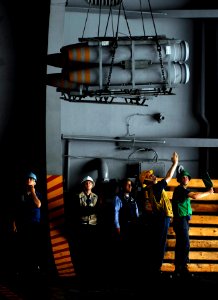 US Navy 080926-N-9928E-126 Sailors lower ordnance in the hangar bay aboard the Nimitz-class aircraft carrier USS John C. Stennis (CVN 74)