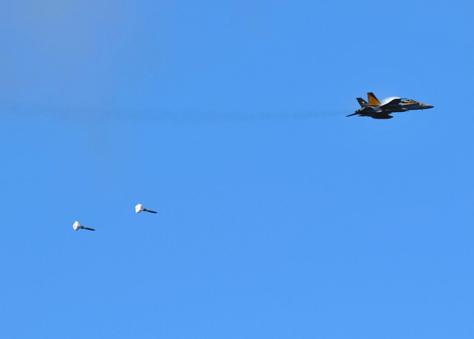 US Navy 080929-N-7981E-416 An F-A-18C Hornet drops a high-drag practice bomb alongside the Nimitz-class aircraft carrier USS Abraham Lincoln (CVN 72)
