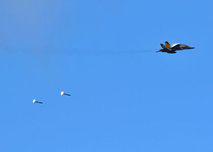 US Navy 080929-N-7981E-416 An F-A-18C Hornet drops a high-drag practice bomb alongside the Nimitz-class aircraft carrier USS Abraham Lincoln (CVN 72)