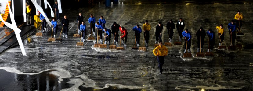 US Navy 101215-N-2475A-084 Sailors scrub the deck aboard USS John C. Stennis (CVN 74)
