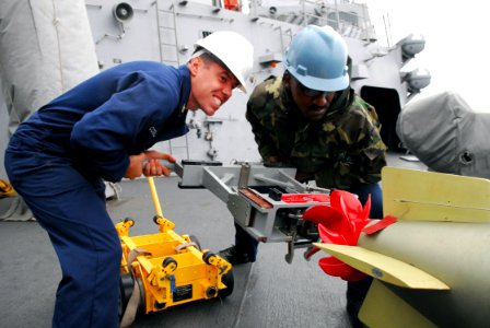 US Navy 080929-N-2013O-001 Gunner's Mate 1st Class Justin McConnell and Gunner's Mate 2nd Class Lamar Varnedoe upload a torpedo photo