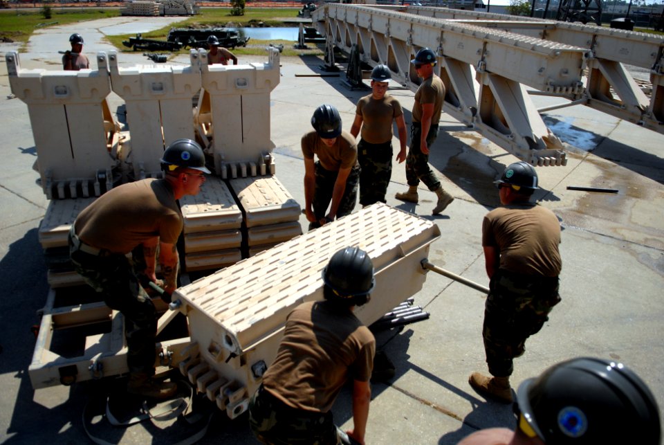 US Navy 080930-N-3674H-099 Seabees attach a section of a medium girder bridge