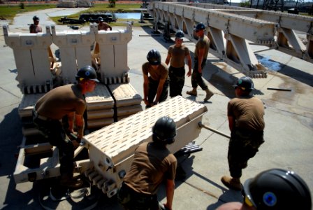 US Navy 080930-N-3674H-099 Seabees attach a section of a medium girder bridge