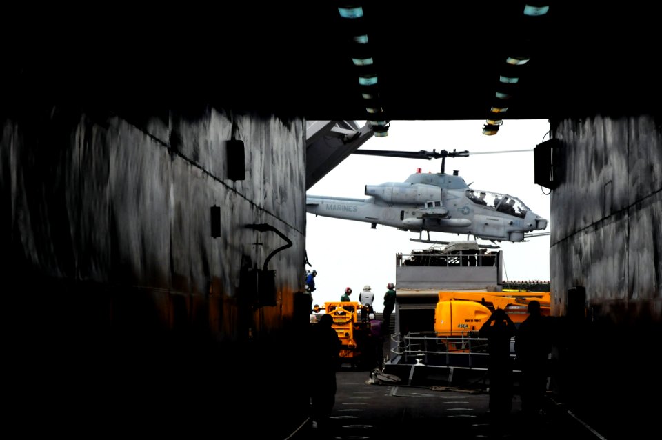 US Navy 101215-N-3659B-205 Sailors aboard USS Comstock (LSD 45) watch an AH-1 Cobra helicopter lift off from USS Comstock (LSD 45)