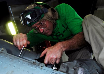 US Navy 080927-N-8593M-145 Chief Aviation Structural Mechanic Stephen F. Kimble paints an HH60H Sea Hawk helicopter assigned to the