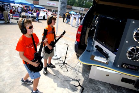 US Navy 080927-N-3271W-107 Patrons at the Okra Strut Festival enjoy playing a game of Guitar Hero photo