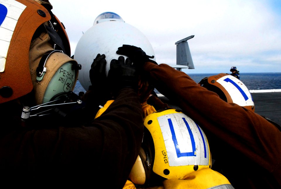 US Navy 080928-N-2610F-089 Flight deck personnel push back an F-A-18C Hornet