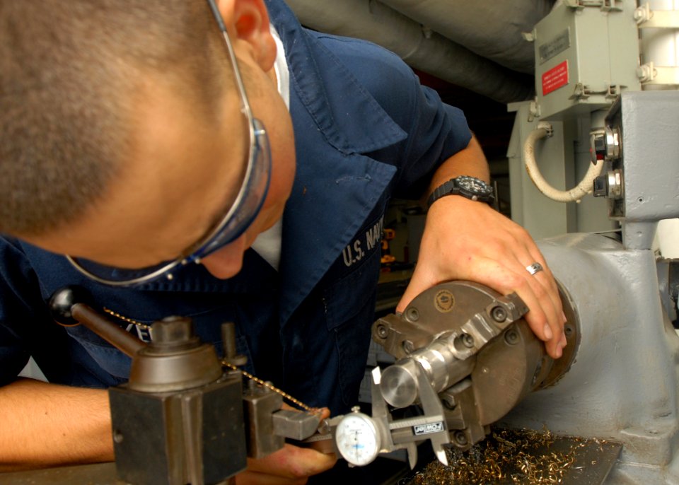 US Navy 080925-N-2456S-078 Machinery Repairman Fireman Ben Kelly uses a dial caliber to measure a piece of metal