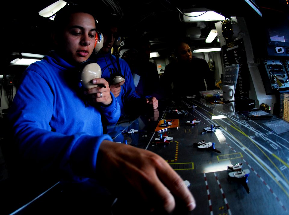 US Navy 080928-N-9928E-017 Aviation Boatswain's Mate (Handling) Airman Robert Reveles marks aircraft movements on the