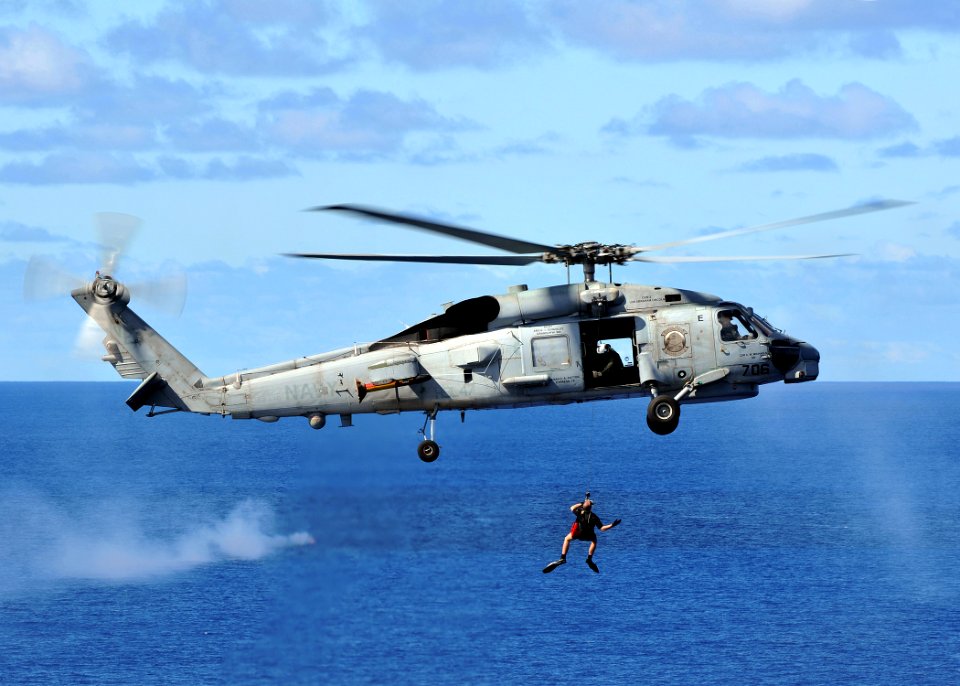 US Navy 080929-N-7981E-498 A rescue swimmer is hoisted back into an SH-60B Sea Hawk helicopter assigned to the