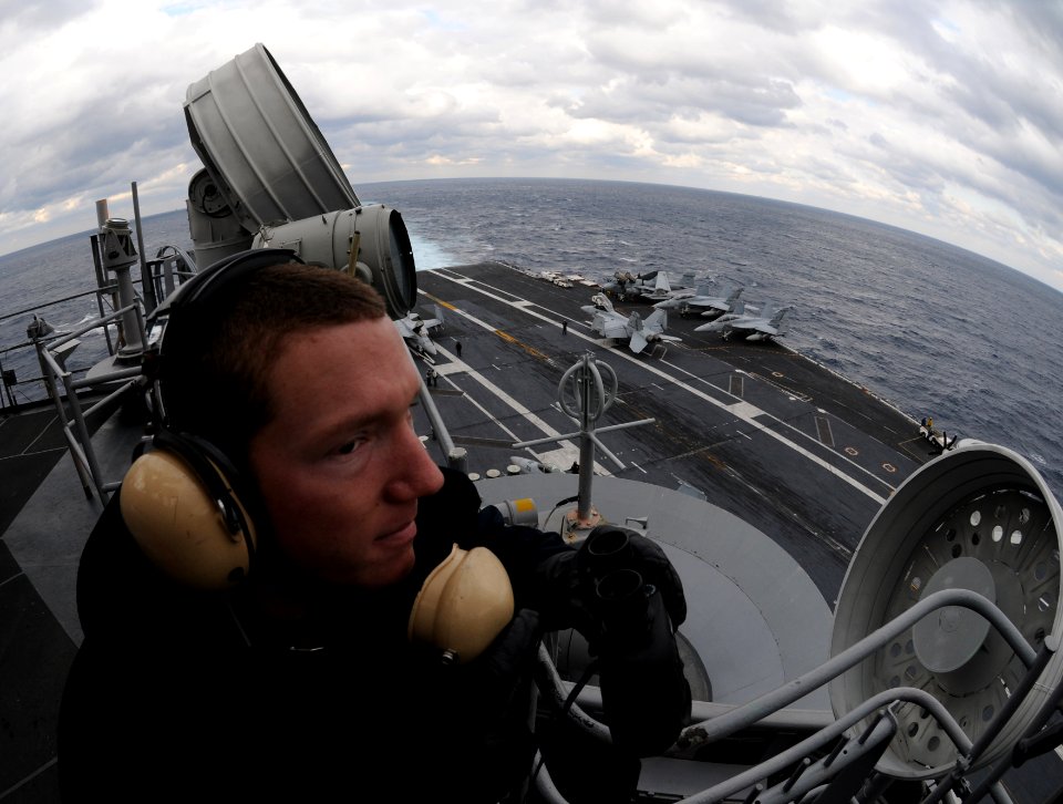 US Navy 101209-N-9693M-008 Seaman Robert Stallcup stands port lookout watch aboard USS Enterprise (CVN 65)