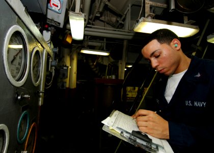 US Navy 080926-N-4236E-014 Machinist's Mate 3rd Class Jason Ferrante takes readings in the engine room