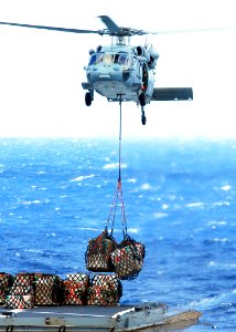 US Navy 080929-N-2183K-093 An MH-60S Sea Hawk lifts cargo off the flight deck of the Military Sealift Command fleet replenishment oiler USNS Pecos (T-A0 197)