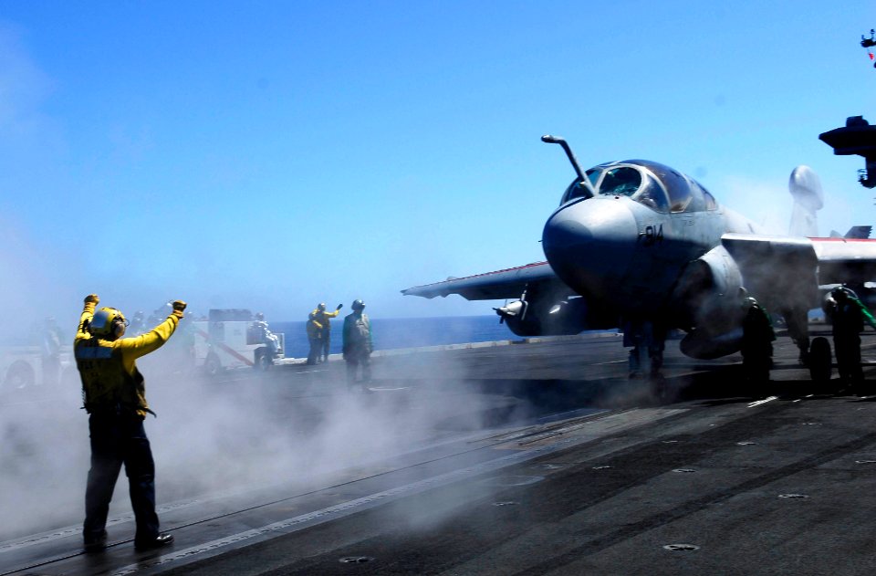 US Navy 081001-N-9928E-087 Aviation Boatswain's Mate (Handling) 2nd Class Richard Hernandez, from El Paso, Texas, directs an EA-6B Prowler assigned to the