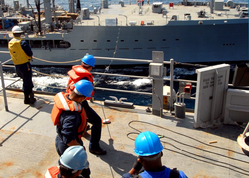US Navy 080930-N-3392P-036 Sailors aboard the amphibious dock landing ship USS Carter Hall (LSD 50) tend lines from the Military Sealift Command fleet replenishment oiler USNS Tippecanoe (T-AO 199) during a replenishment at sea