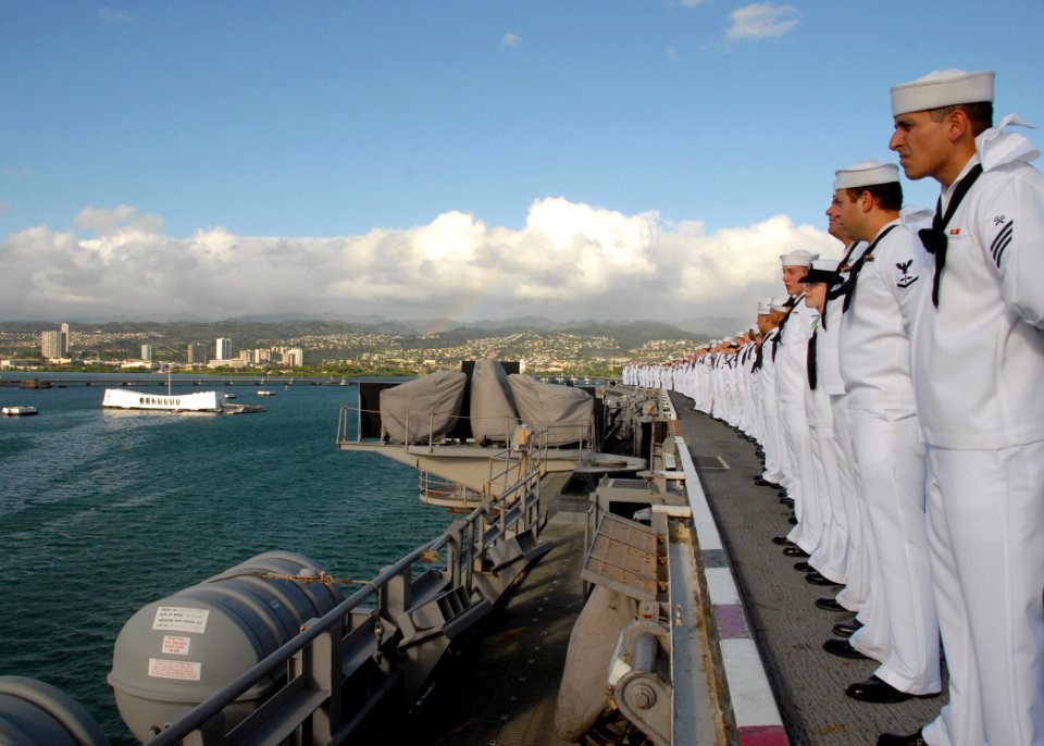 US Navy 080930-N-5617R-065 Sailors man the rails as the aircraft carrier USS Abraham Lincoln (CVN 72) sails past the USS Arizona Memorial at Pearl Harbor Naval Station