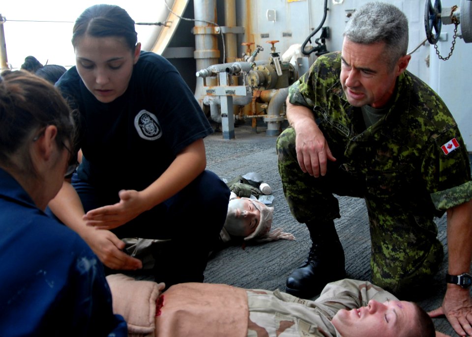 US Navy 080926-N-9134V-043 Canadian Army Capt. Rory MacDonald comforts a simulated victim