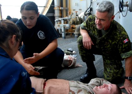 US Navy 080926-N-9134V-043 Canadian Army Capt. Rory MacDonald comforts a simulated victim