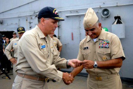 US Navy 081003-N-9818V-198 Capt. Patrick Scanlon, commanding officer of the submarine tender USS Frank Cable (AS 40), presents Master Chief Petty Officer of the Navy (MCPON) Joe R. Campa Jr. with a ship's coin during an all-han