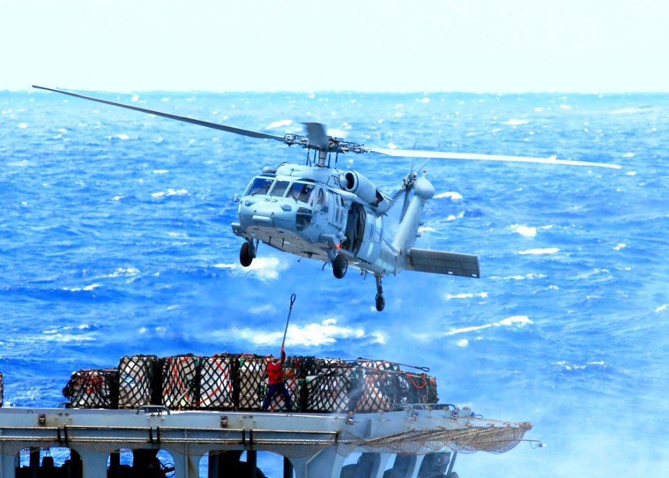 US Navy 080929-N-2183K-052 A Sailor attaches a cargo pendant to an MH-60S Sea Hawk