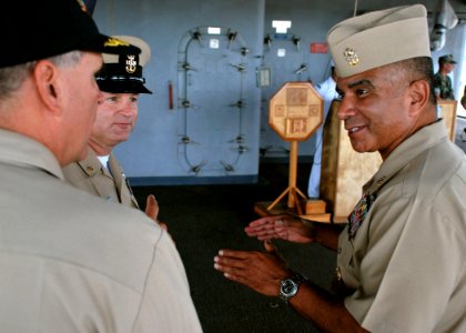 US Navy 081003-N-1722W-023 Master Chief Petty Officer of the Navy (MCPON) Joe R. Campa Jr. speaks with Capt. Pat Scanlon, commanding officer of the submarine tender USS Frank Cable (AS 40), and Frank Cable Command Master Chief photo