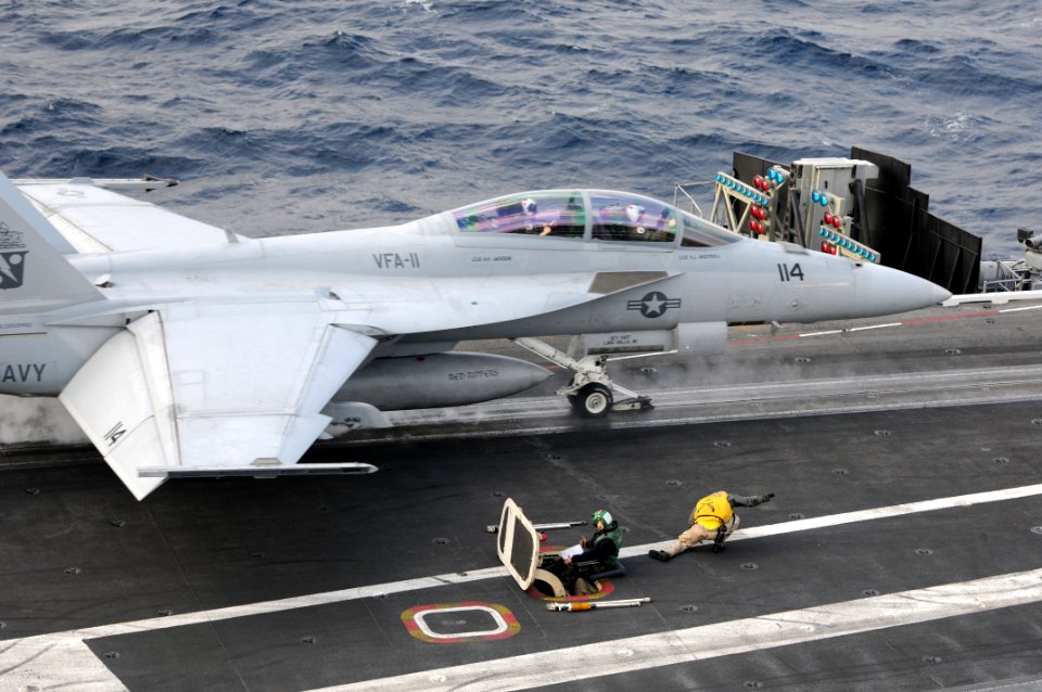 US Navy 101209-N-9693M-011 A shooter ducks safely out of the way as an F-A-18E Super Hornet assigned to the Knighthawks of Strike Fighter Squadron