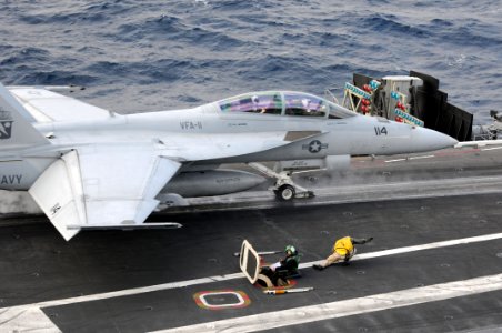 US Navy 101209-N-9693M-011 A shooter ducks safely out of the way as an F-A-18E Super Hornet assigned to the Knighthawks of Strike Fighter Squadron