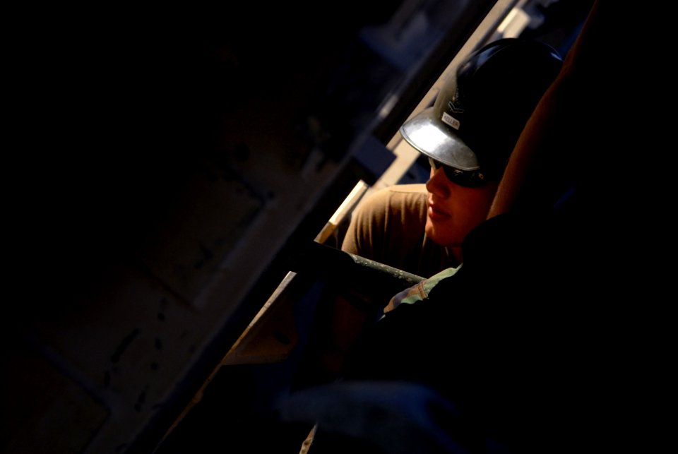 US Navy 081001-N-3674H-135 Construction Electrician 2nd Class Richard Keller attaches a section of a medium girder bridge