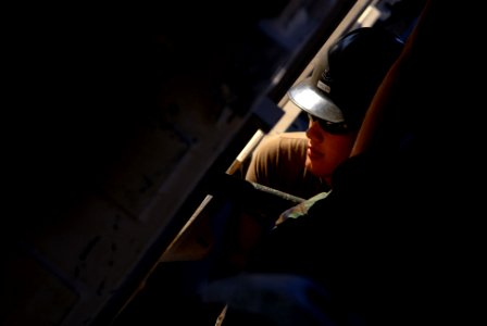 US Navy 081001-N-3674H-135 Construction Electrician 2nd Class Richard Keller attaches a section of a medium girder bridge