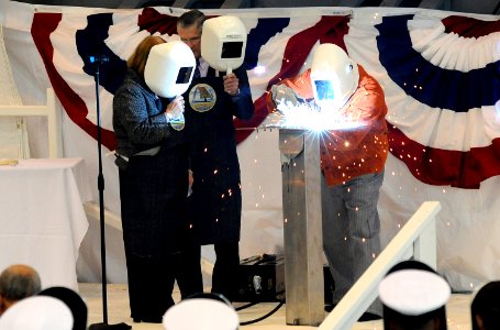 US Navy 080927-N-8467N-001 Caesar De Sanpo Sr. welds the initials of Mrs. Rebecca W. Gates into the keel of PCU Missouri (SSN 780)