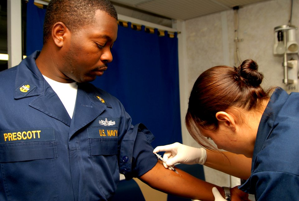 US Navy 081001-N-9134V-025 Seaman Ashley Gonzalez administers a purified protein derivative shot to Chief Quartermaster Melvin Prescott