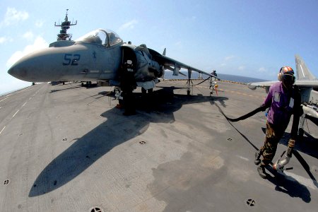 US Navy 081001-N-4856C-022 Aviation Boatswain's Mate (Fuels) 1st Class Jason Lewis carries a fuel hose across the flight deck of the multi-purpose amphibious assault ship USS Iwo Jima (LHD 7) photo