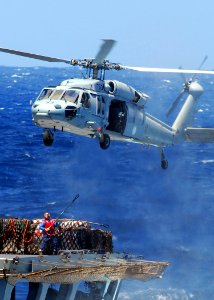 US Navy 080929-N-2183K-063 A Sailor attaches a cargo pendant to an MH-60S Sea Hawk