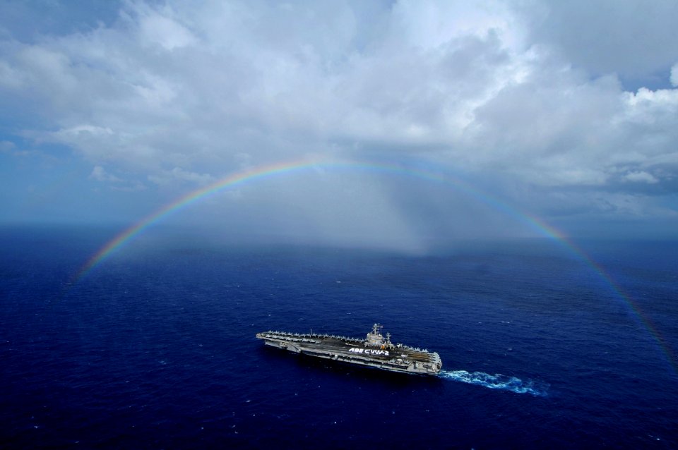 US Navy 080927-N-7981E-418 The aircraft carrier USS Abraham Lincoln (CVN 72) passes under a rainbow as Sailors from Lincoln and Carrier Air Wing (CVW) 2 participate in a