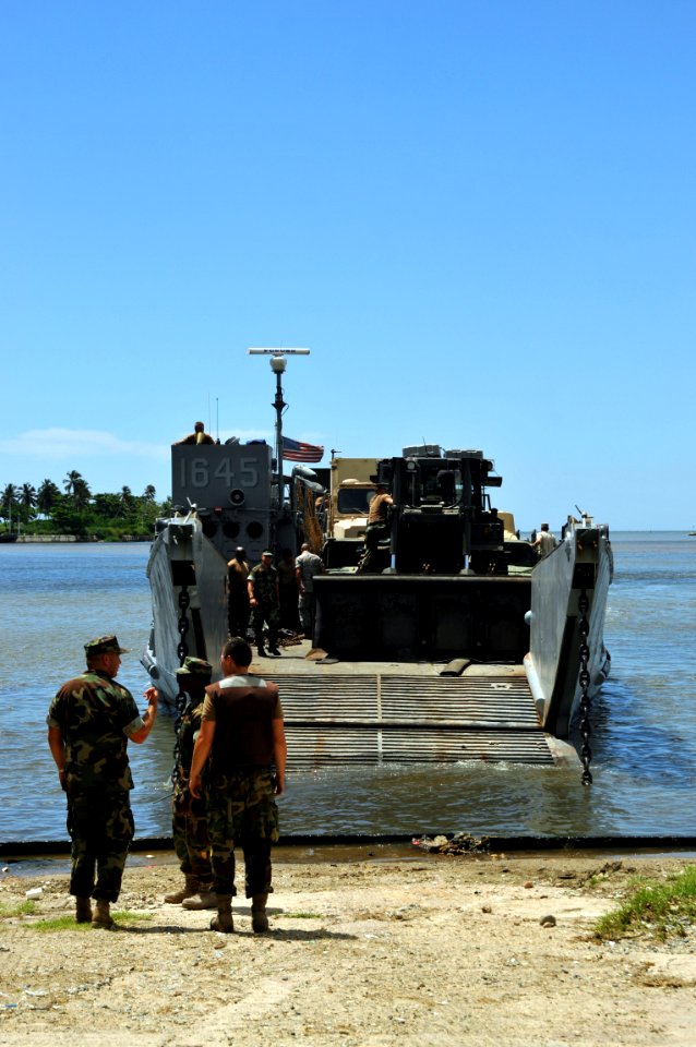 US Navy 081003-N-8907D-592 Assault Craft Unit (ACU) 2 personnel begin off loading vehicles and equipment