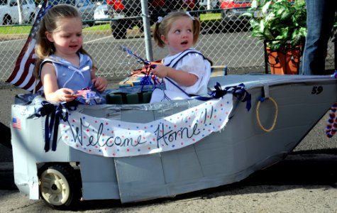 US Navy 081001-N-9758L-006 Children sit in a scale model of the Arleigh Burke-class guided-missile destroyer USS Russell (DDG 59)
