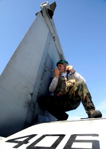 US Navy 081001-N-7571S-003 Aviation Structural Mechanic 3rd Class Douglas Pistone tightens fasteners on an F-A-18 strike fighter aboard the aircraft carrier USS Theodore Roosevelt (CVN 71)