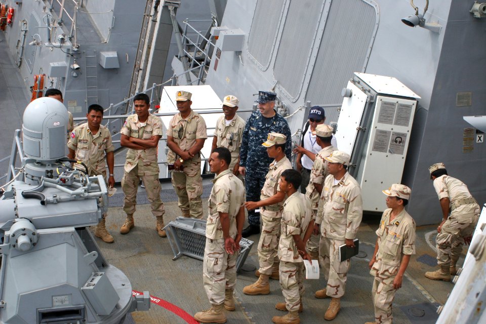 US Navy 101204-N-4780J-032 Chief Machinery Repairman Tim Groeneveld shows a 25 mm chain gun to Royal Cambodia Navy sailors during a tour of the gui
