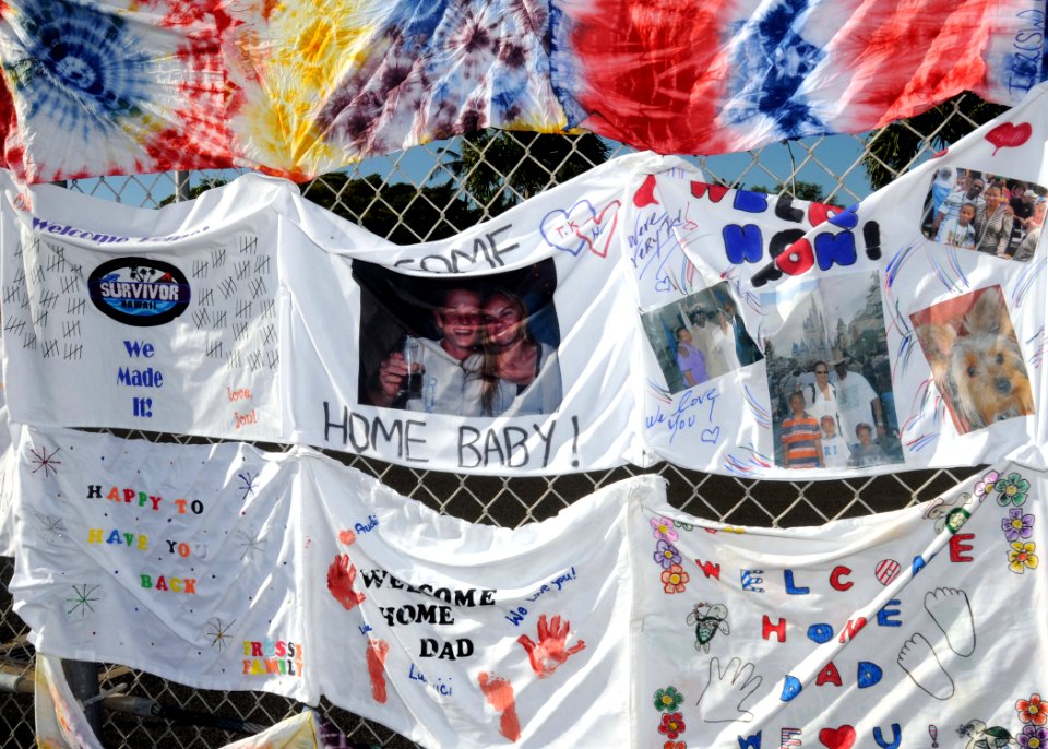 US Navy 081001-N-9758L-015 Welcome home banners hang on the pier fence as the Arleigh Burke-class guided-missile destroyer USS Russell (DDG 59) makes her way pier side