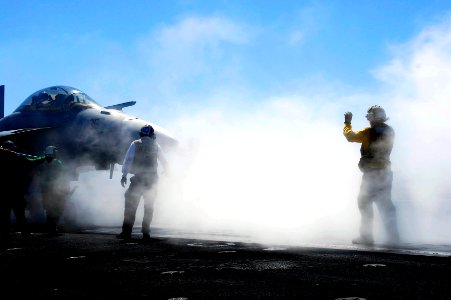 US Navy 081001-N-9928E-046 Aviation Boatswain's Mate (Handling) 3rd Class Mike Condlin, from Fayetteville, N.C., directs an F-A-18F Super Hornet strike fighter assigned to the