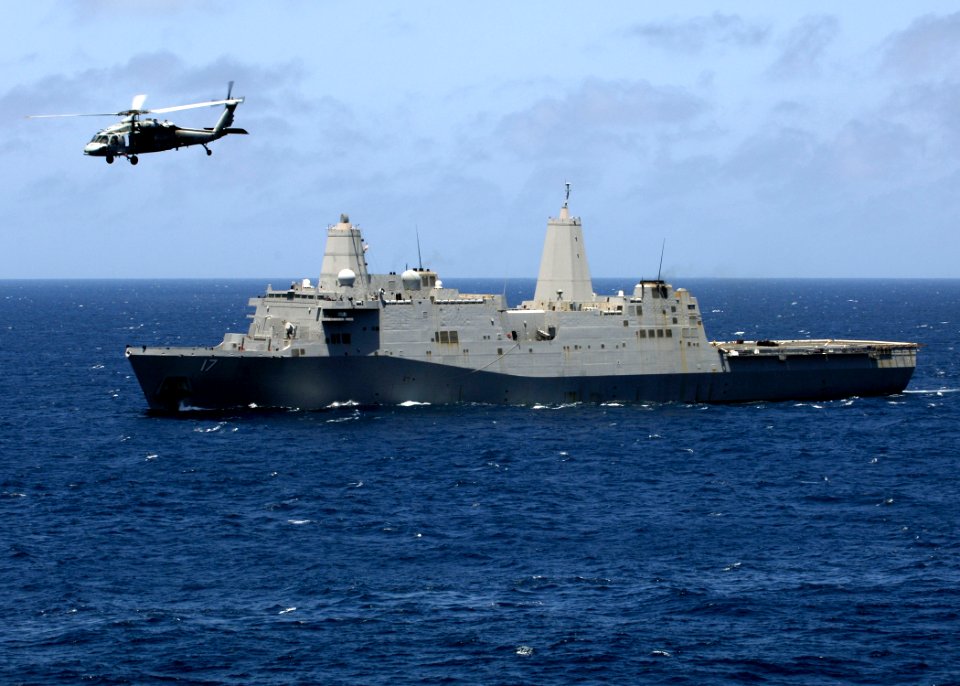 US Navy 081002-N-4236E-087 An MH-60S Sea Hawk passes by the amphibious transport dock ship USS San Antonio (LPD 17)
