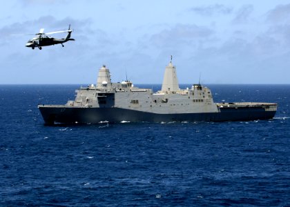 US Navy 081002-N-4236E-087 An MH-60S Sea Hawk passes by the amphibious transport dock ship USS San Antonio (LPD 17)