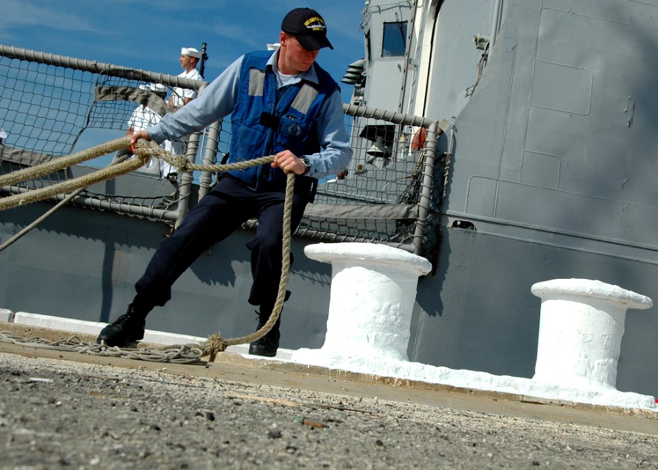 US Navy 081005-N-1522S-010 A Sailor attaches a mooring line as the guided-missile frigate USS McInerney (FFG 8) returns to homeport at Naval Station Mayport after a six-month deployment