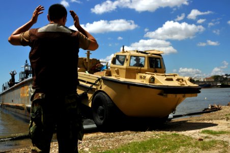 US Navy 081003-N-8907D-461 Assault Craft Unit (ACU) 2 personnel begin off loading vehicles and equipment