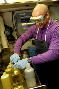 US Navy 081002-N-4954I-012 Aviation Boatswain's Mate (Fuels) 3rd Class Dejon Kennedy, from Lynchburg, Va., prepares JP-5 aircraft fuel samples for testing aboard the Nimitz-class aircraft carrier USS John C. Stennis (CVN 74)