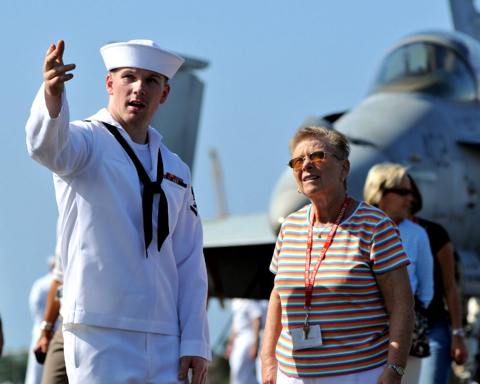 US Navy 081003-N-7981E-239 Aviation Ordnanceman 3rd Class Curtis Burrus, of Cheboygan, Mich., shows his grandmother, Eleanor Nowak, around the flight deck of the aircraft carrier USS Abraham Lincoln (CVN 72)